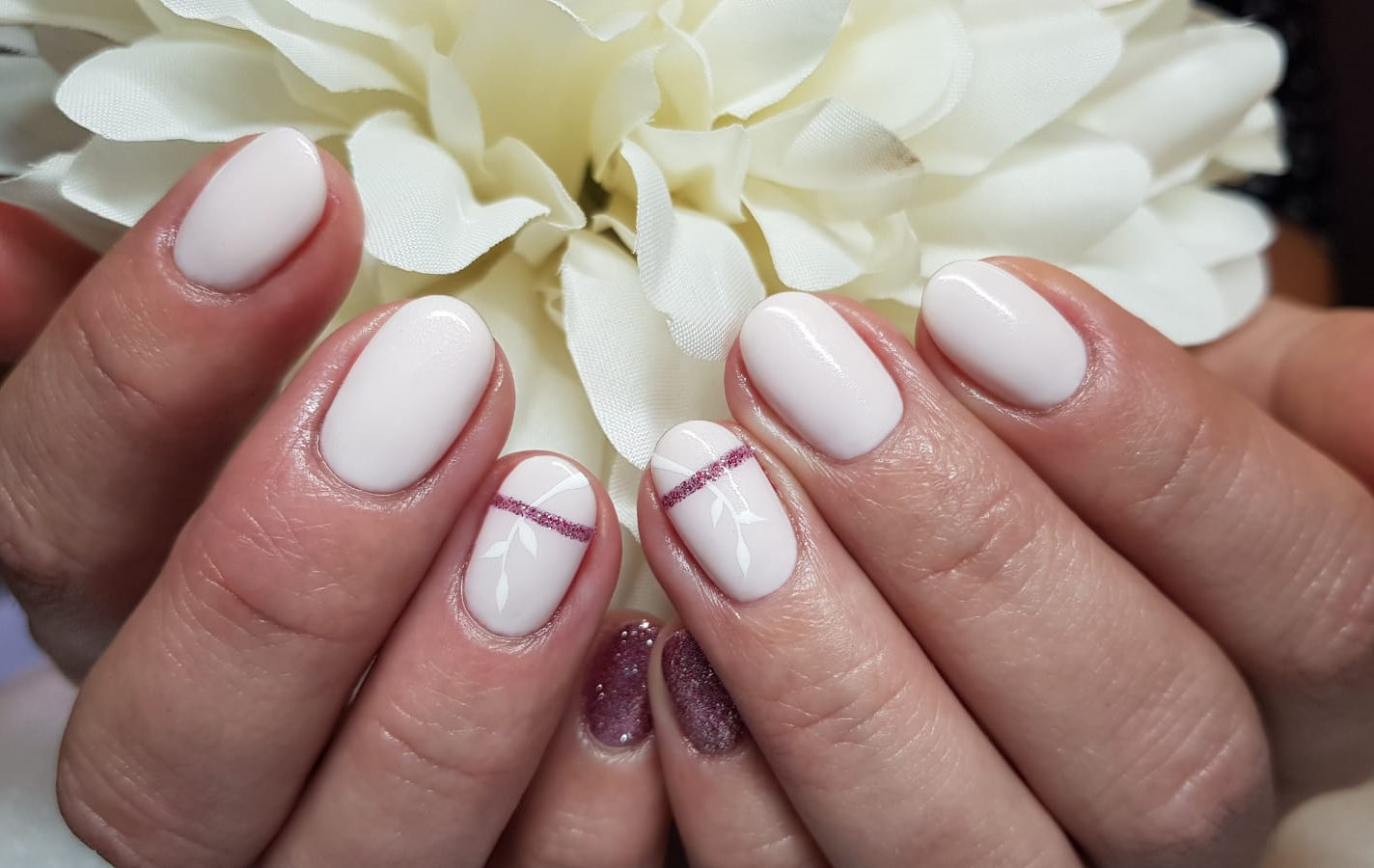 Pale pink nails with white and silver line detail