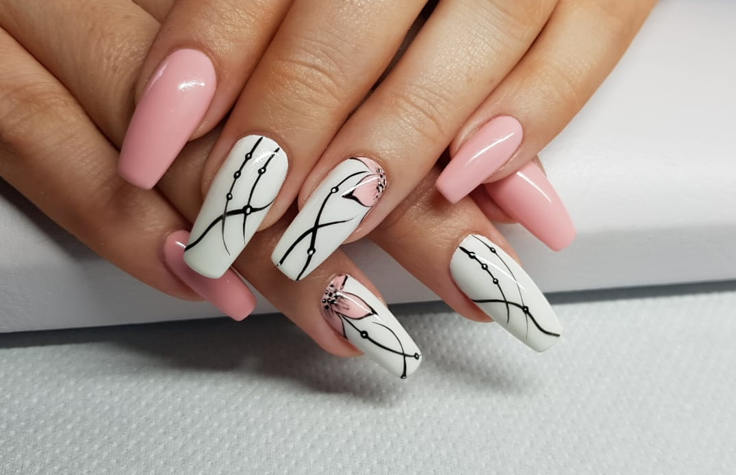 Pink and white nails with black line art