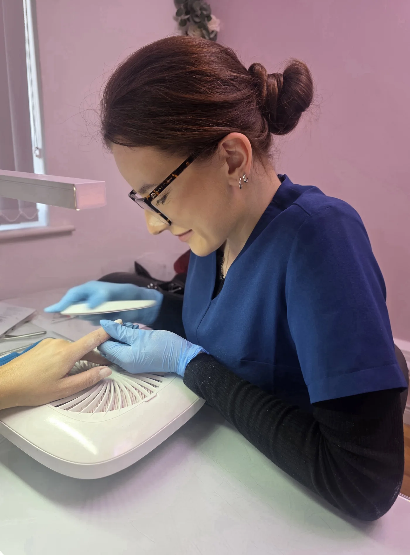 Signature nail technician working on a client’s manicure